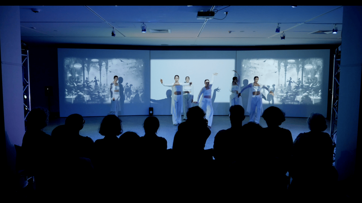 Dancers in front of a projection screen