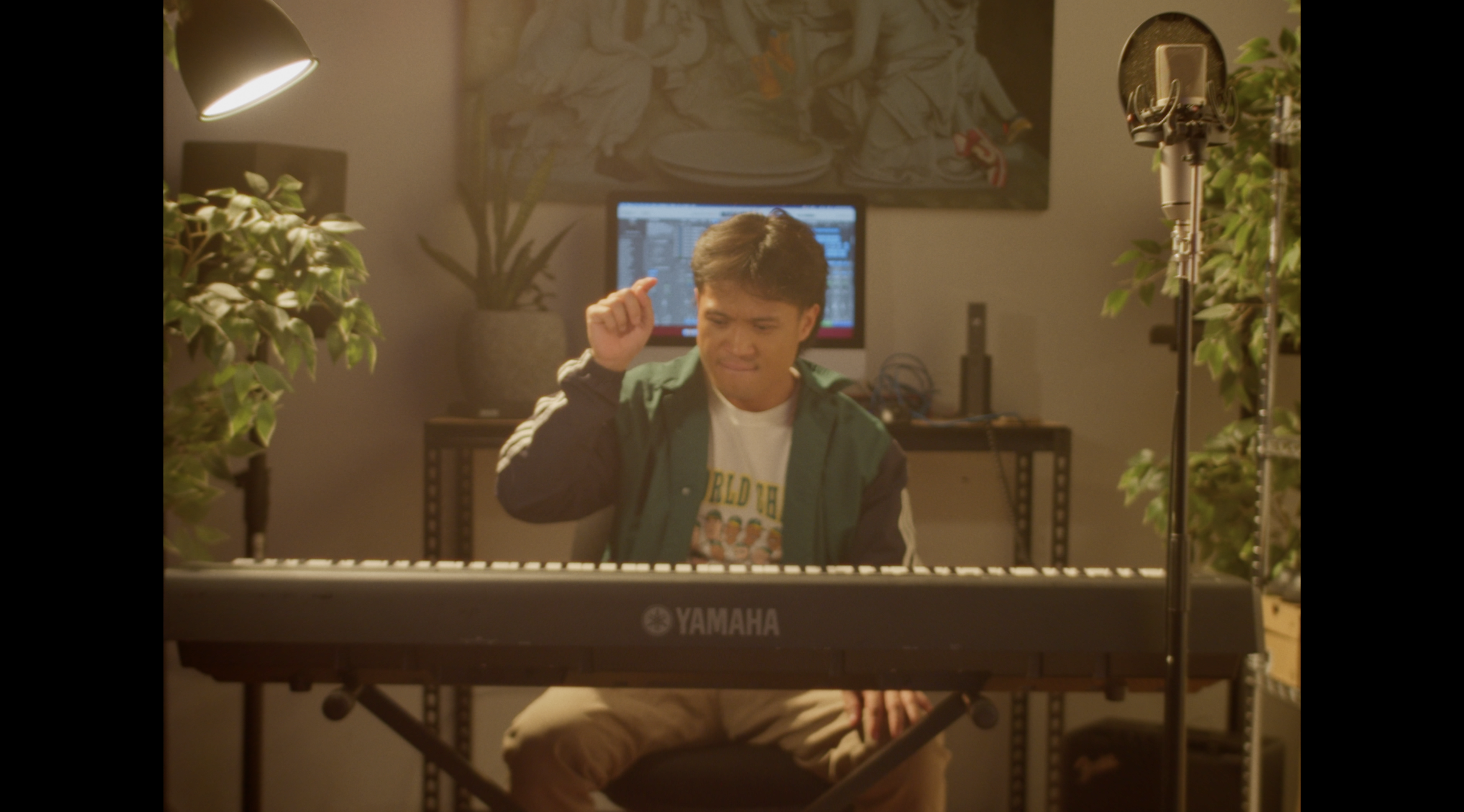 Man sits at keyboard about to play a note